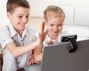 children on a video chat with family
